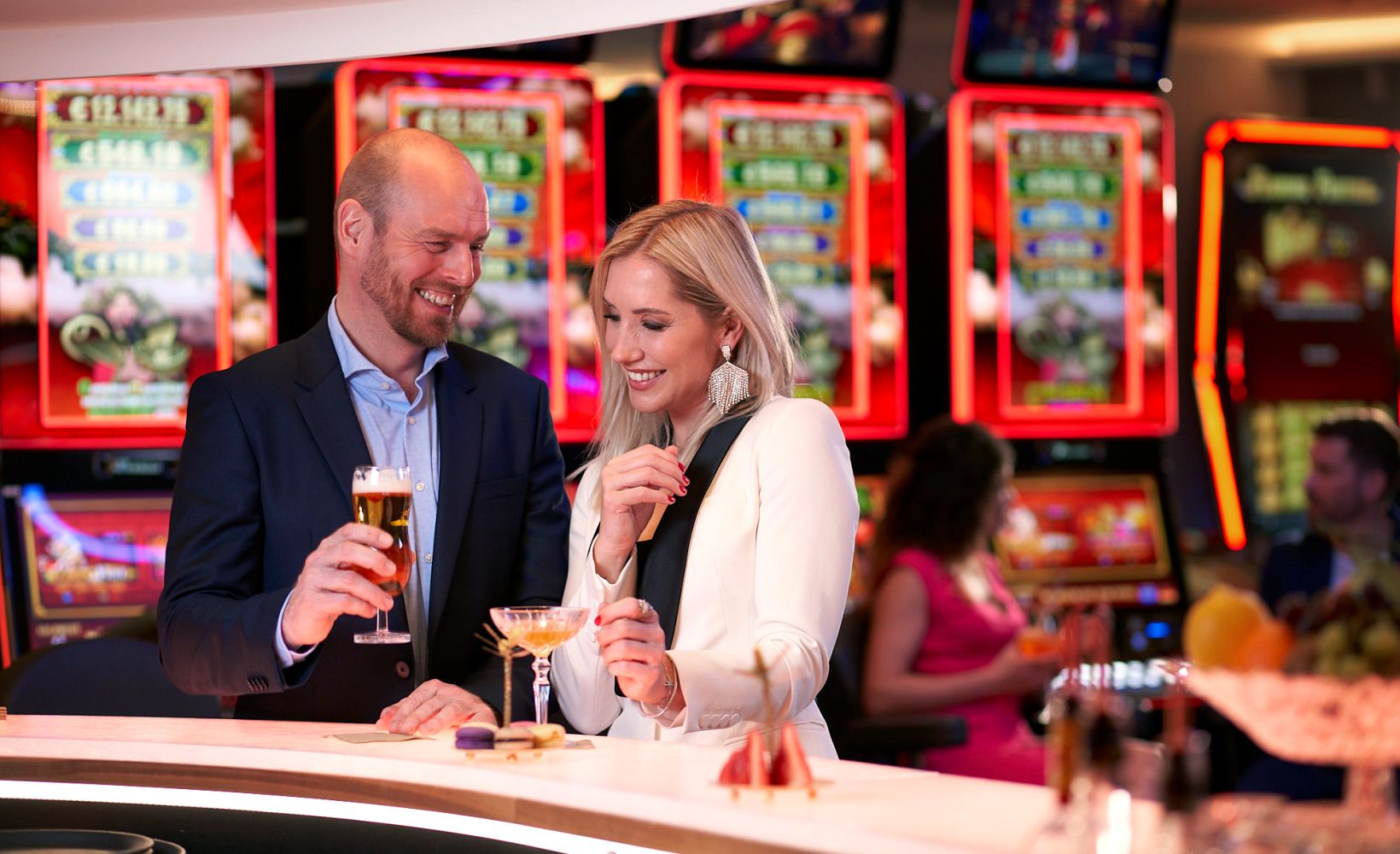 A man talks to a woman at the bar in the Leipzig casino.